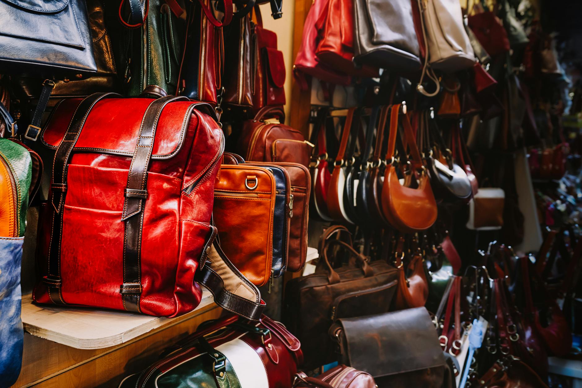 High-end leather handbags displayed in upscale retail environment