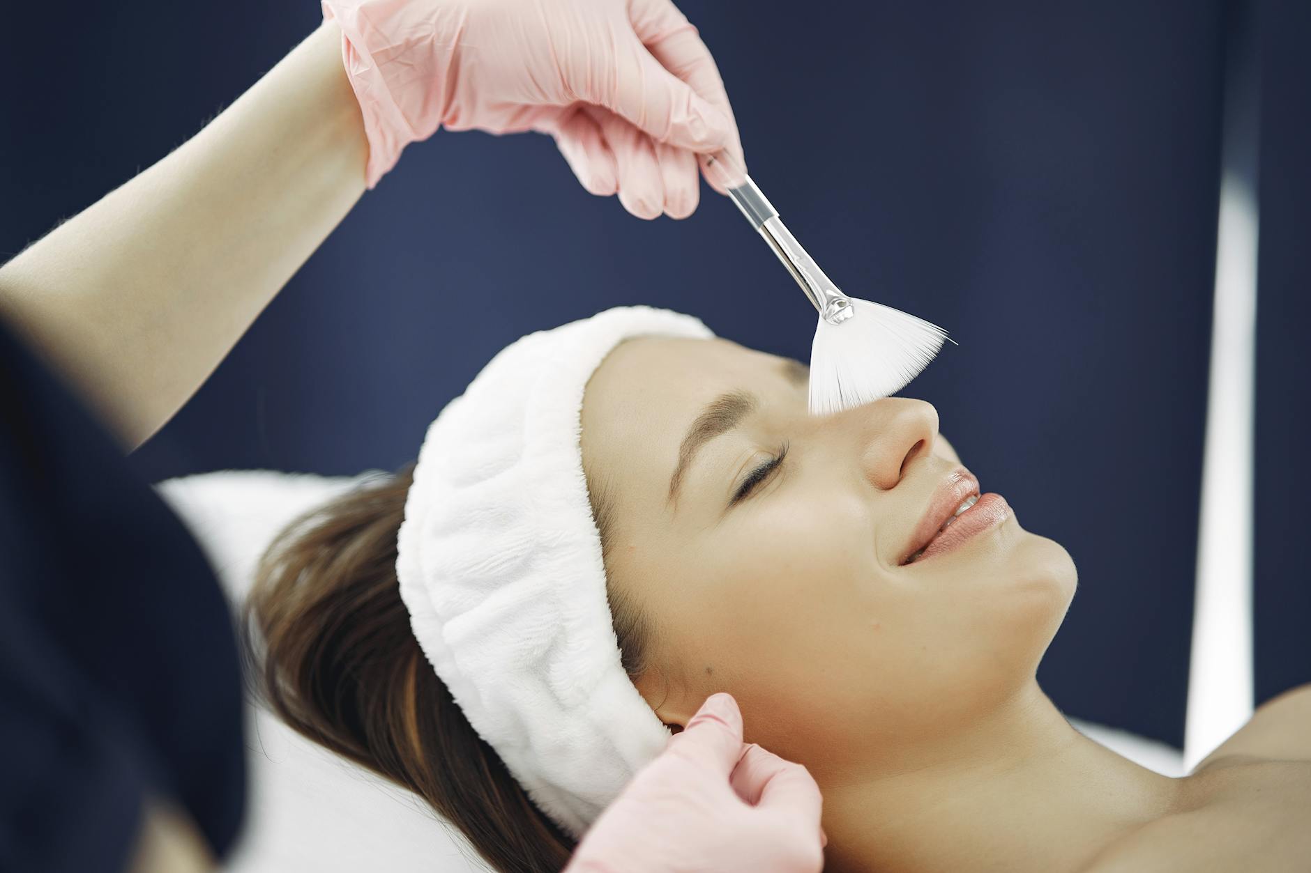Woman receiving relaxing facial treatment at professional spa