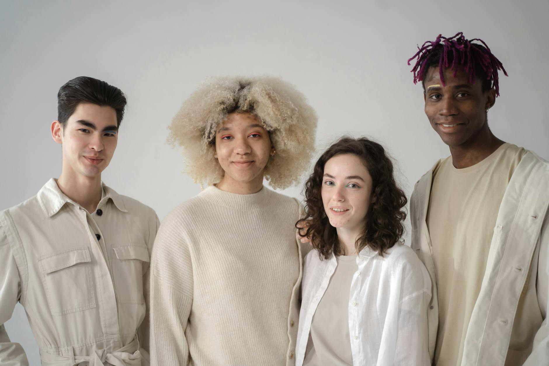 Diverse group of young people socializing together, representing inclusive beauty trends