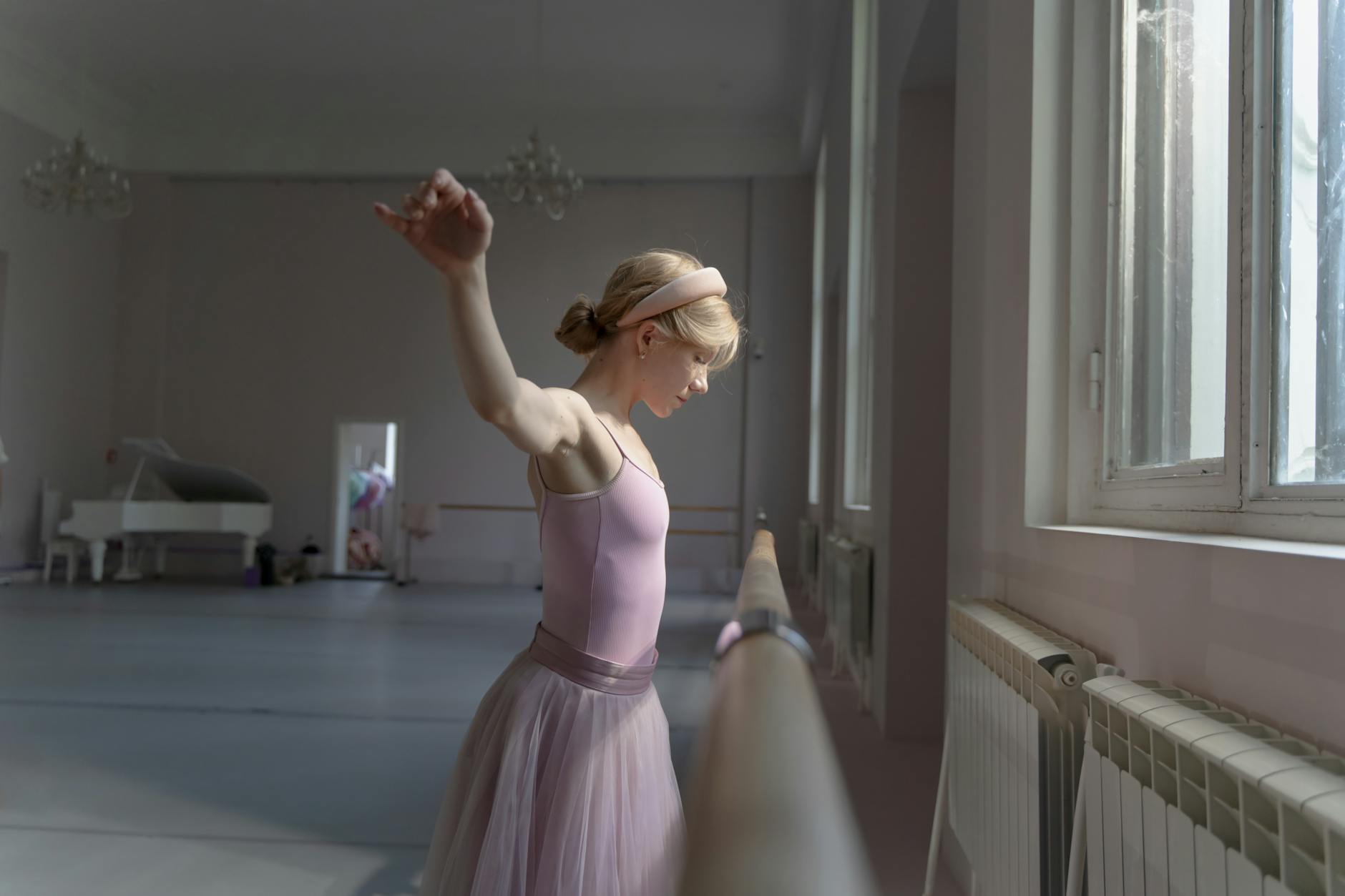 Bright barre studio interior with mirrored walls and ballet barres along the wall