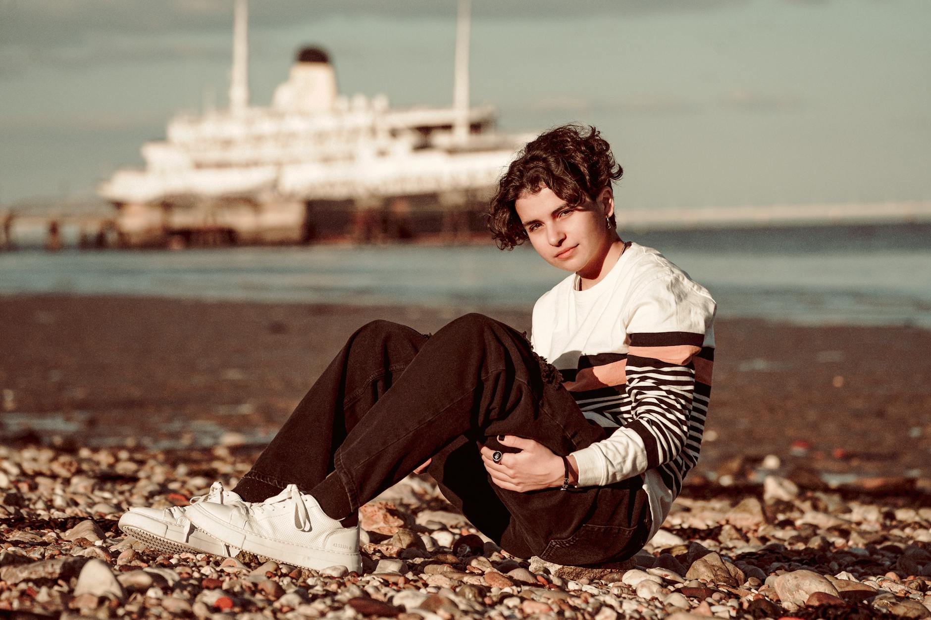 Model wearing a navy striped vest and slim chinos in a clean preppy rowing club style