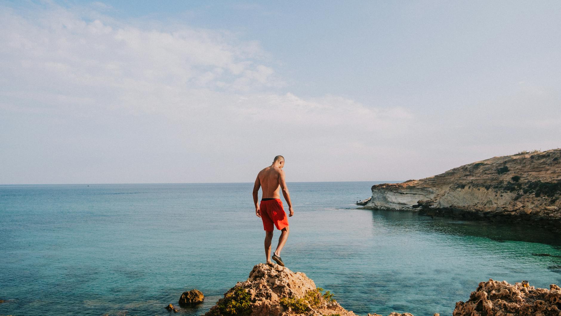 Bold red lifeguard-style shorts laid flat on a light surface