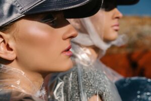 Close-fitting sculptural hat with a smooth dome silhouette inspired by swim cap shapes
