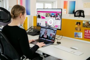 Woman participating in a video conference call from her home office setup
