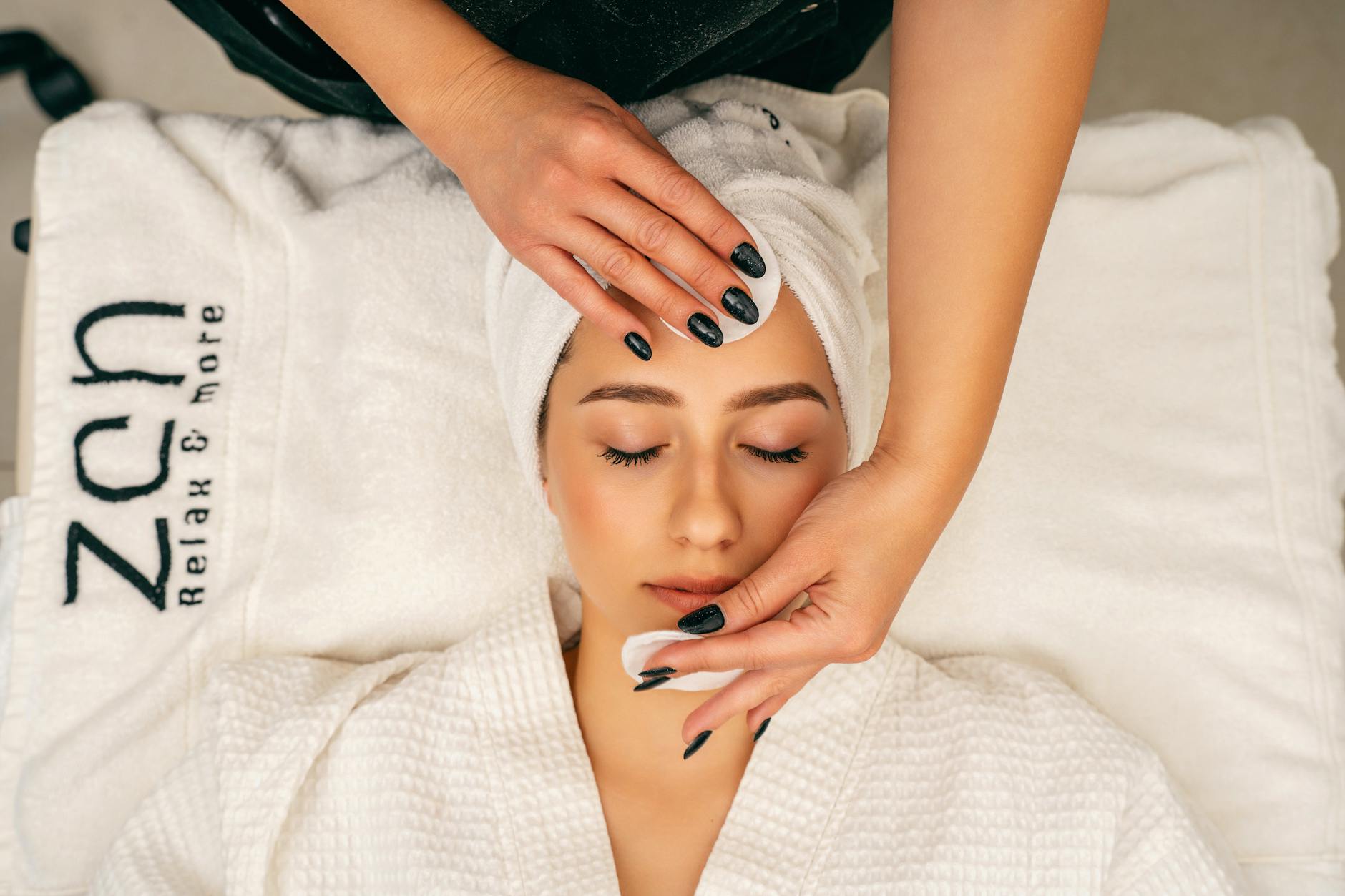 Professional spa treatment room with massage table and skincare equipment setup
