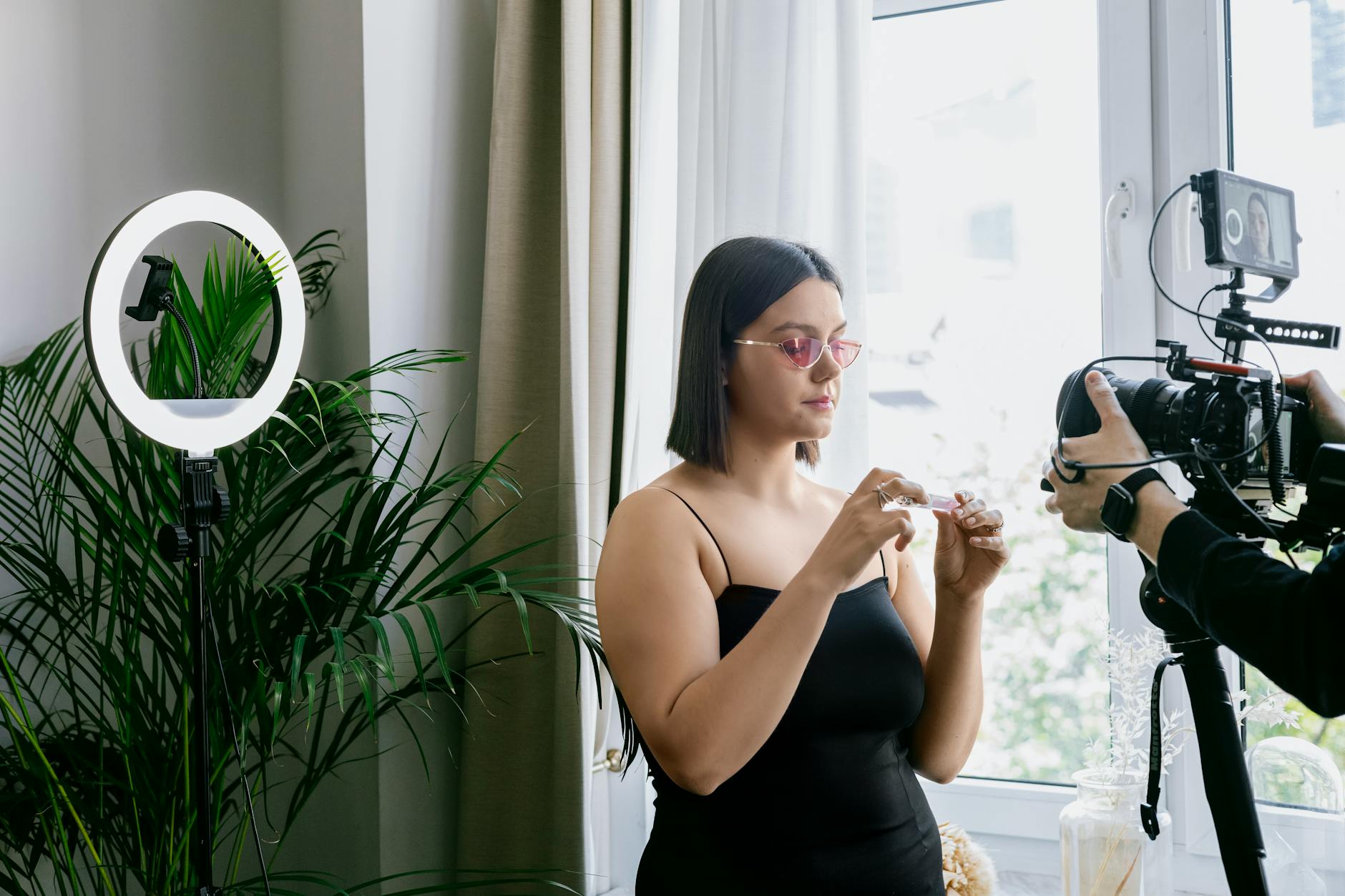 Beauty influencer recording skincare routine with phone camera