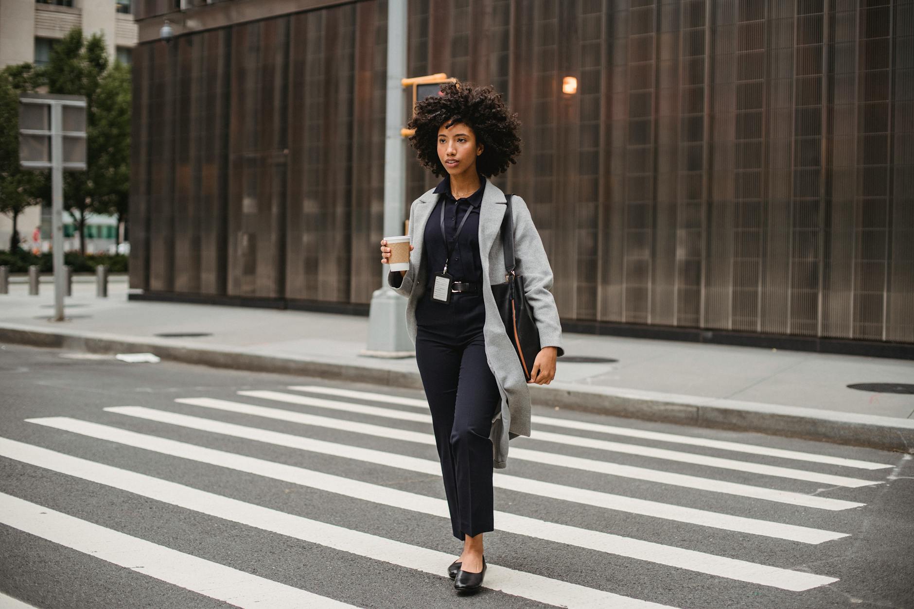 Professional in smart-casual trousers working at a desk in a contemporary workspace