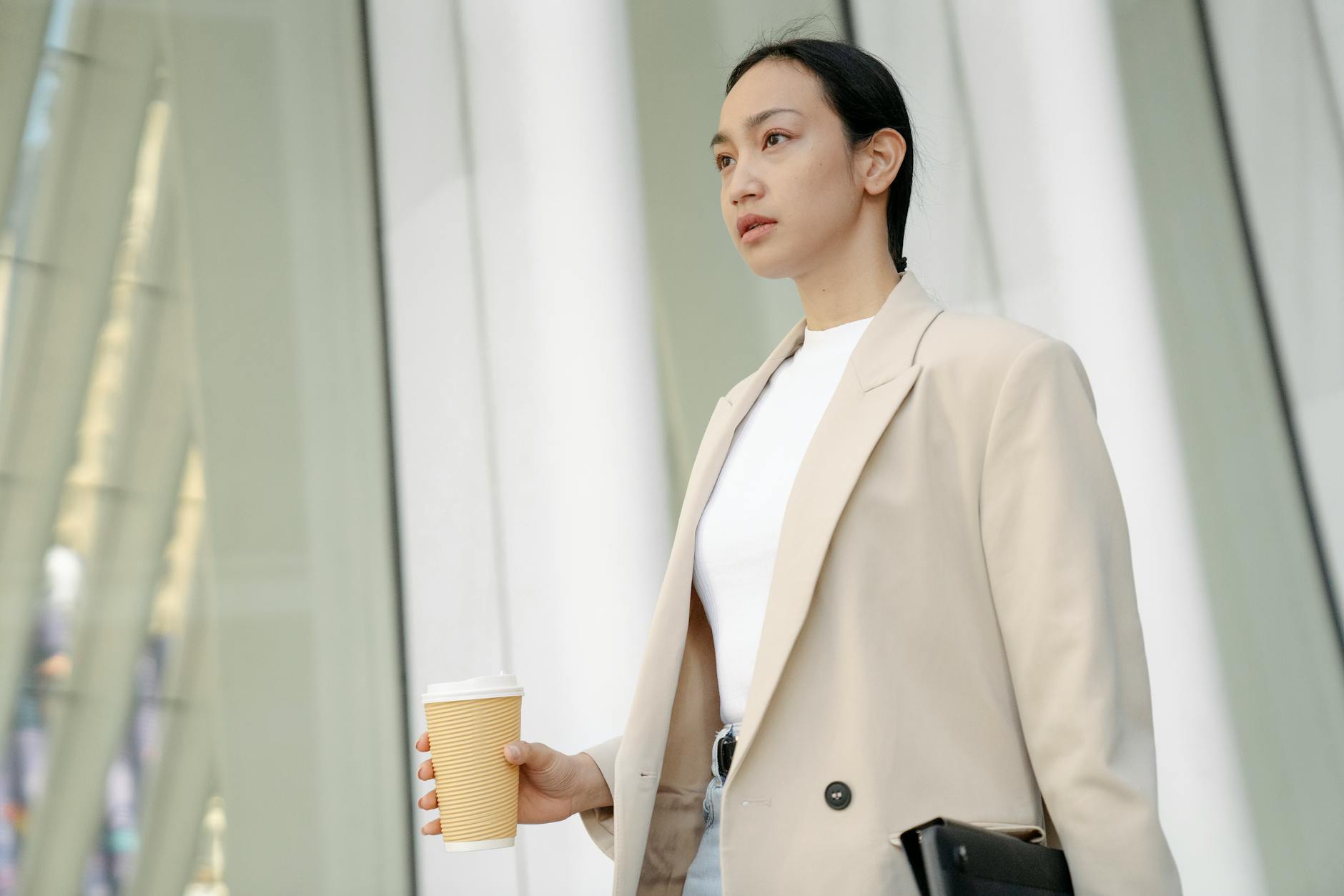 Professional dressed in smart casual layered outfit at a workplace desk