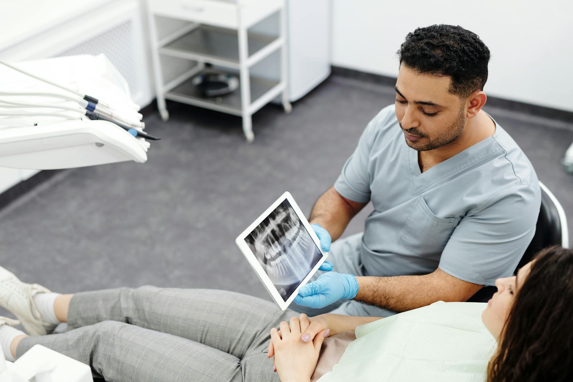 A dentist reviewing treatment options with a patient during a cosmetic consultation