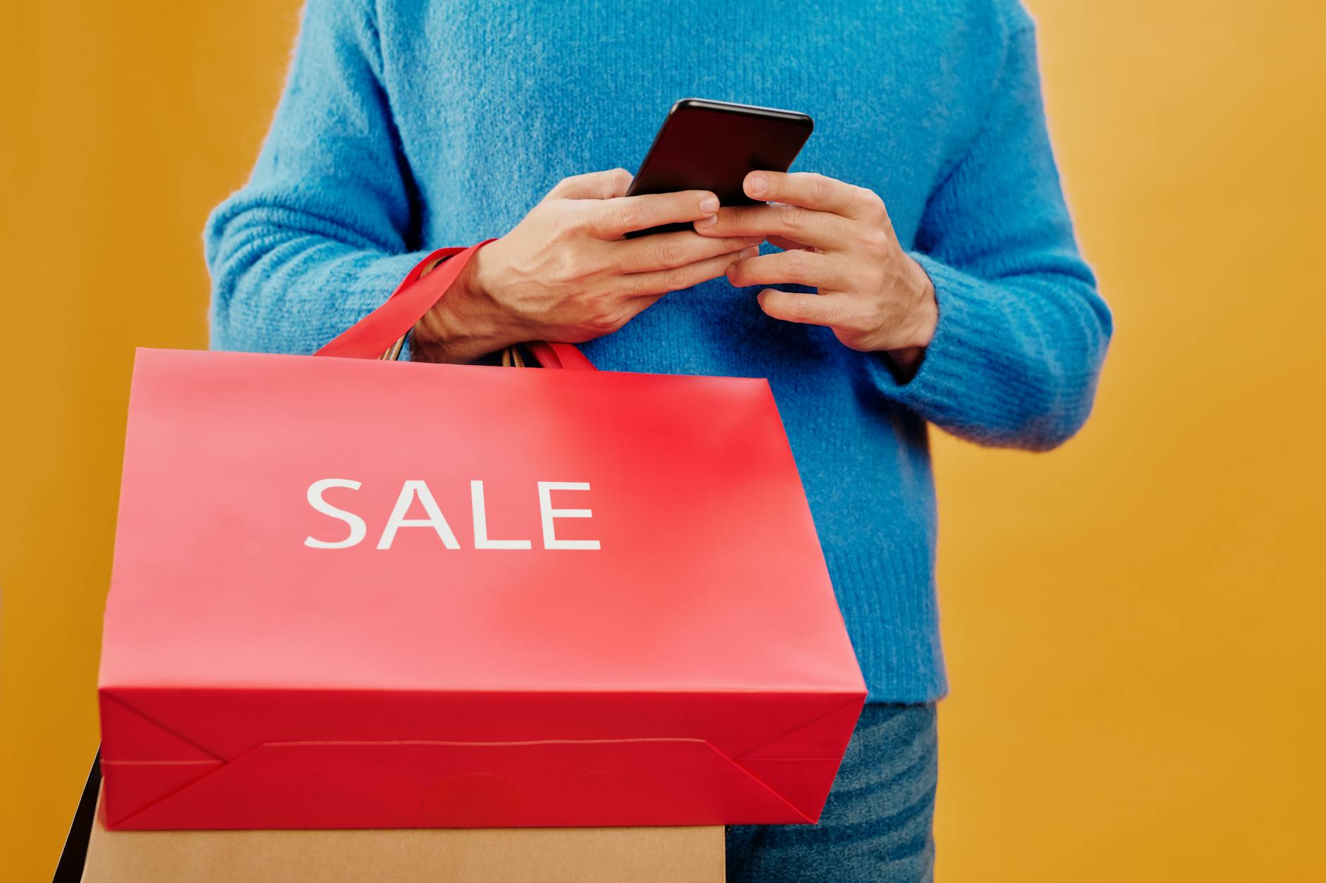 Person browsing resale shopping app on smartphone screen