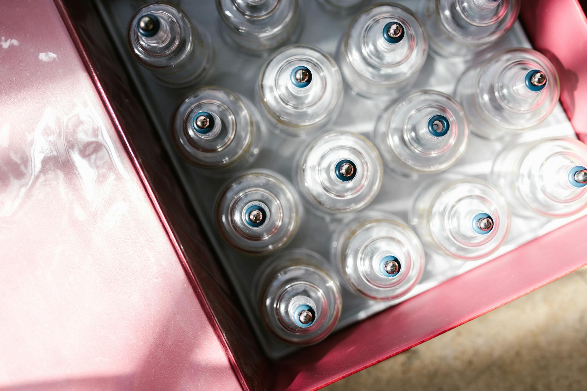 Glass cupping tools arranged on clean white surface