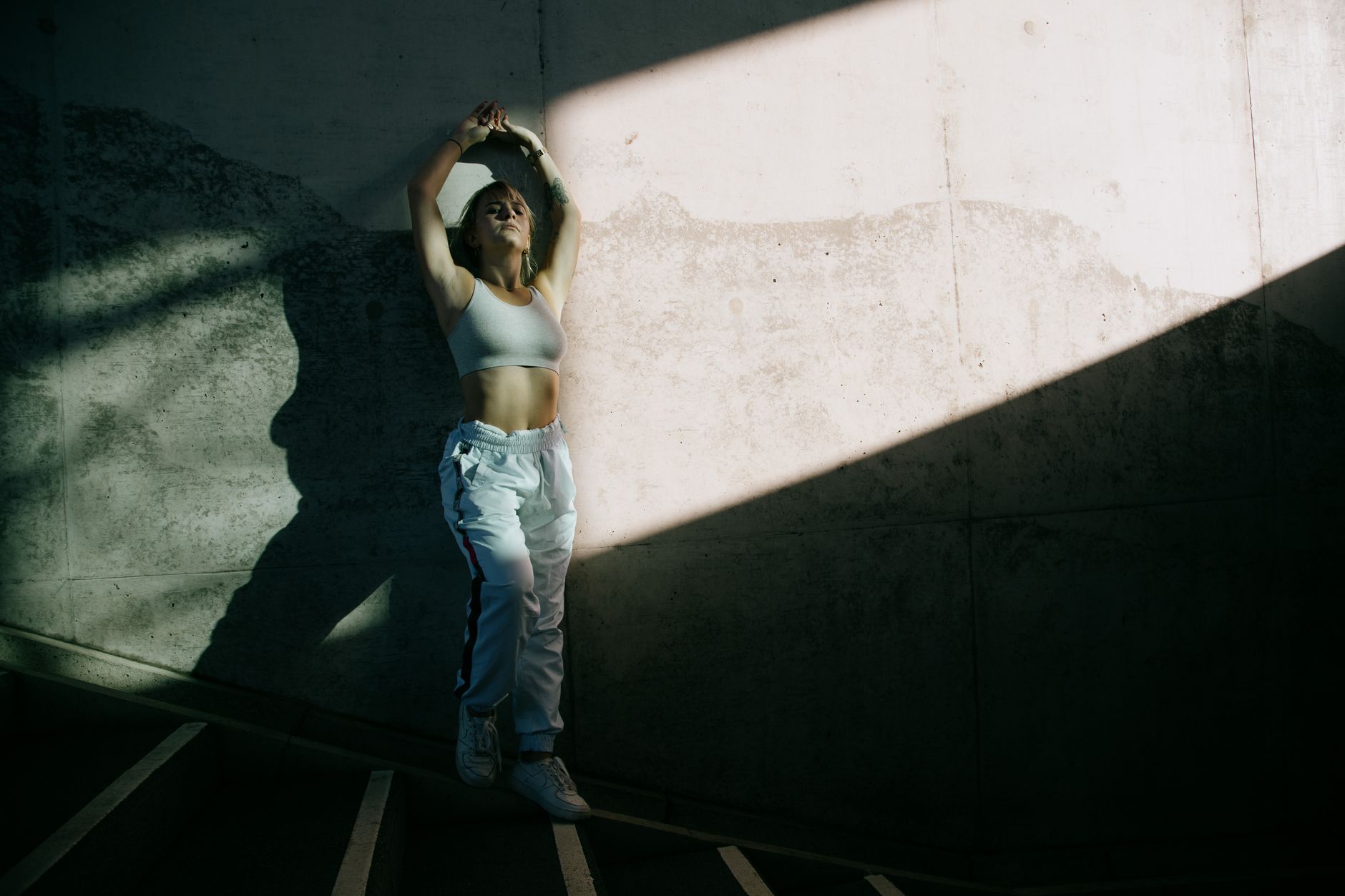 Person styled in soft-toned athleisure wear walking on a city street