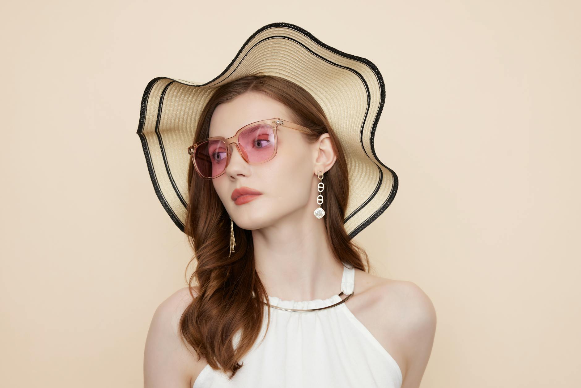 Minimal fashion accessories including a leather bag and simple watch laid flat on a neutral surface