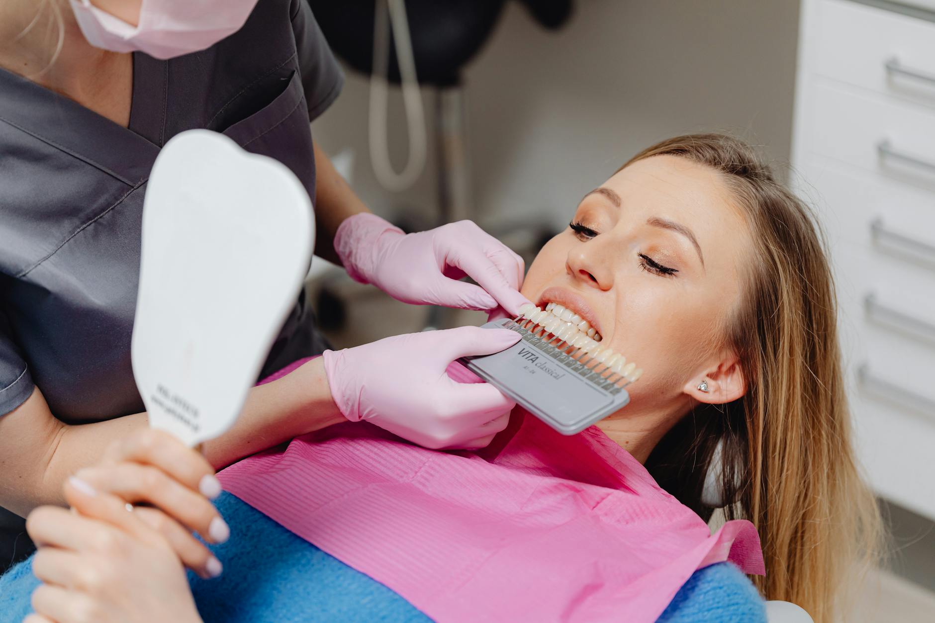 Professional teeth whitening treatment being applied in a dental clinic