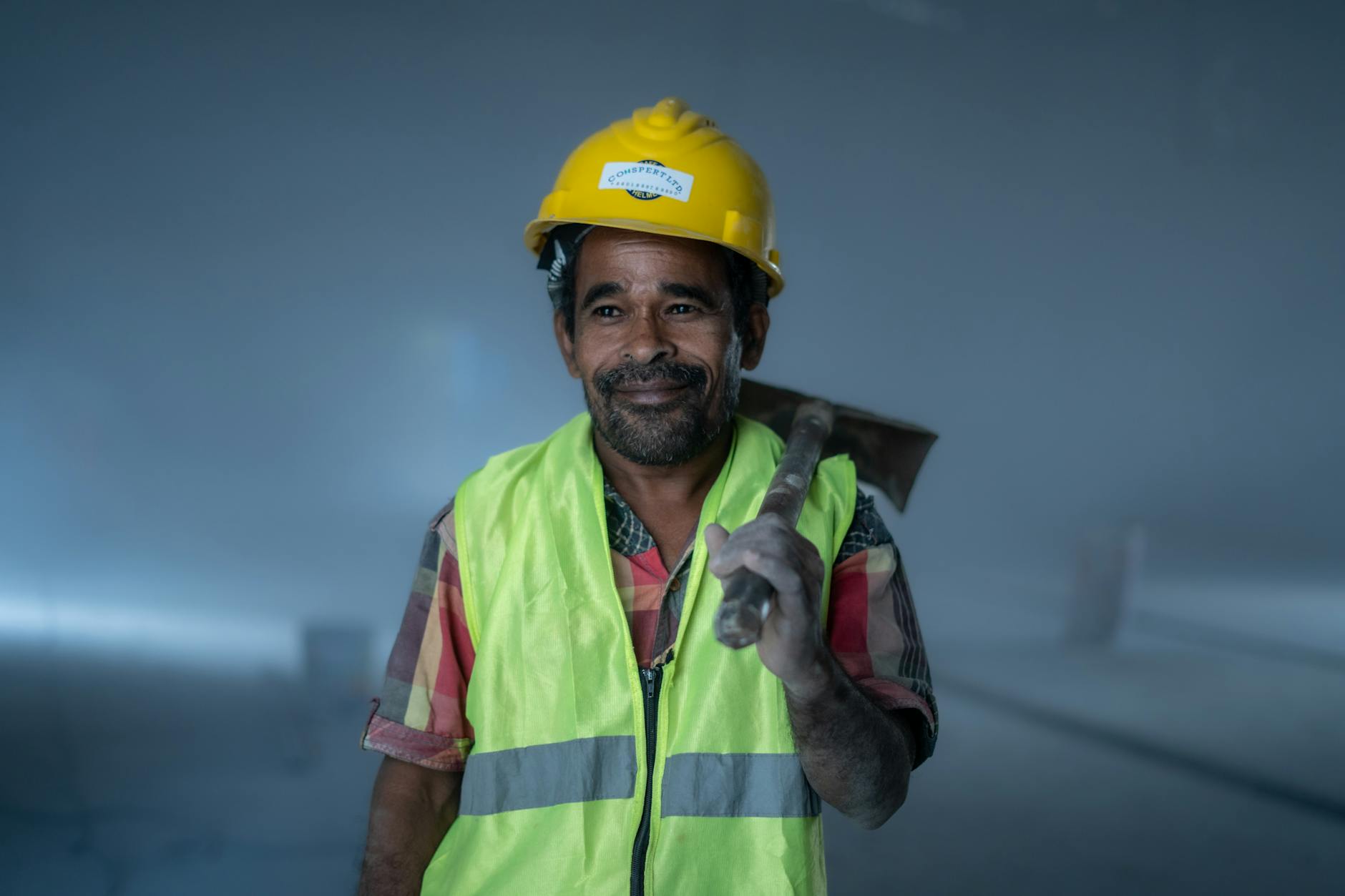 Worker wearing worn work jacket with authentic paint stains and weathering