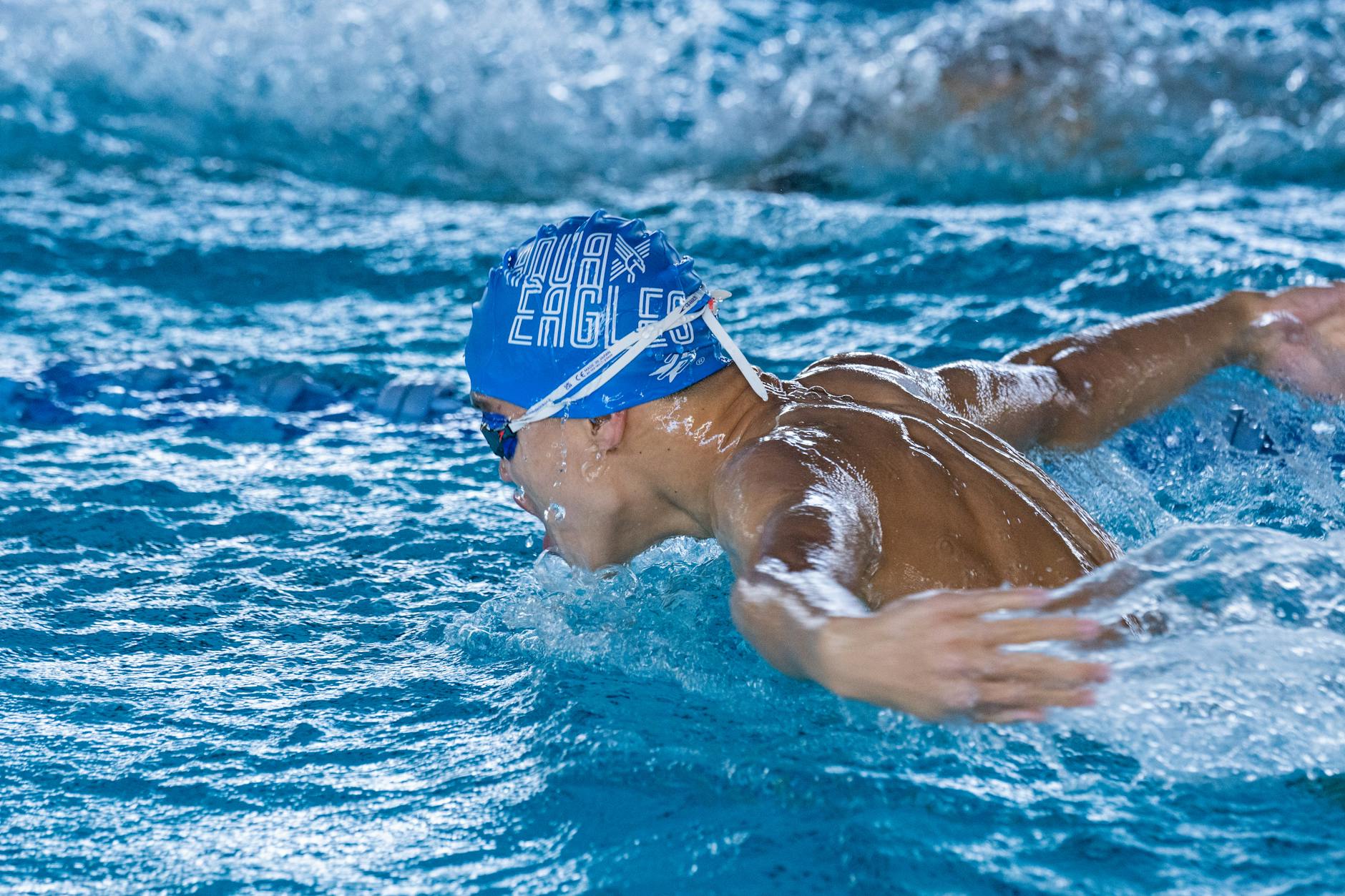 Close-up of a brightly colored water polo cap with ear guards and chin strap