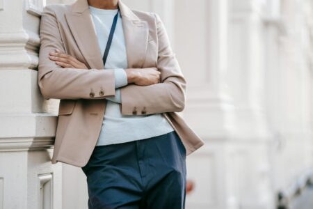 A structured navy blazer with contrast piping worn in a professional office setting