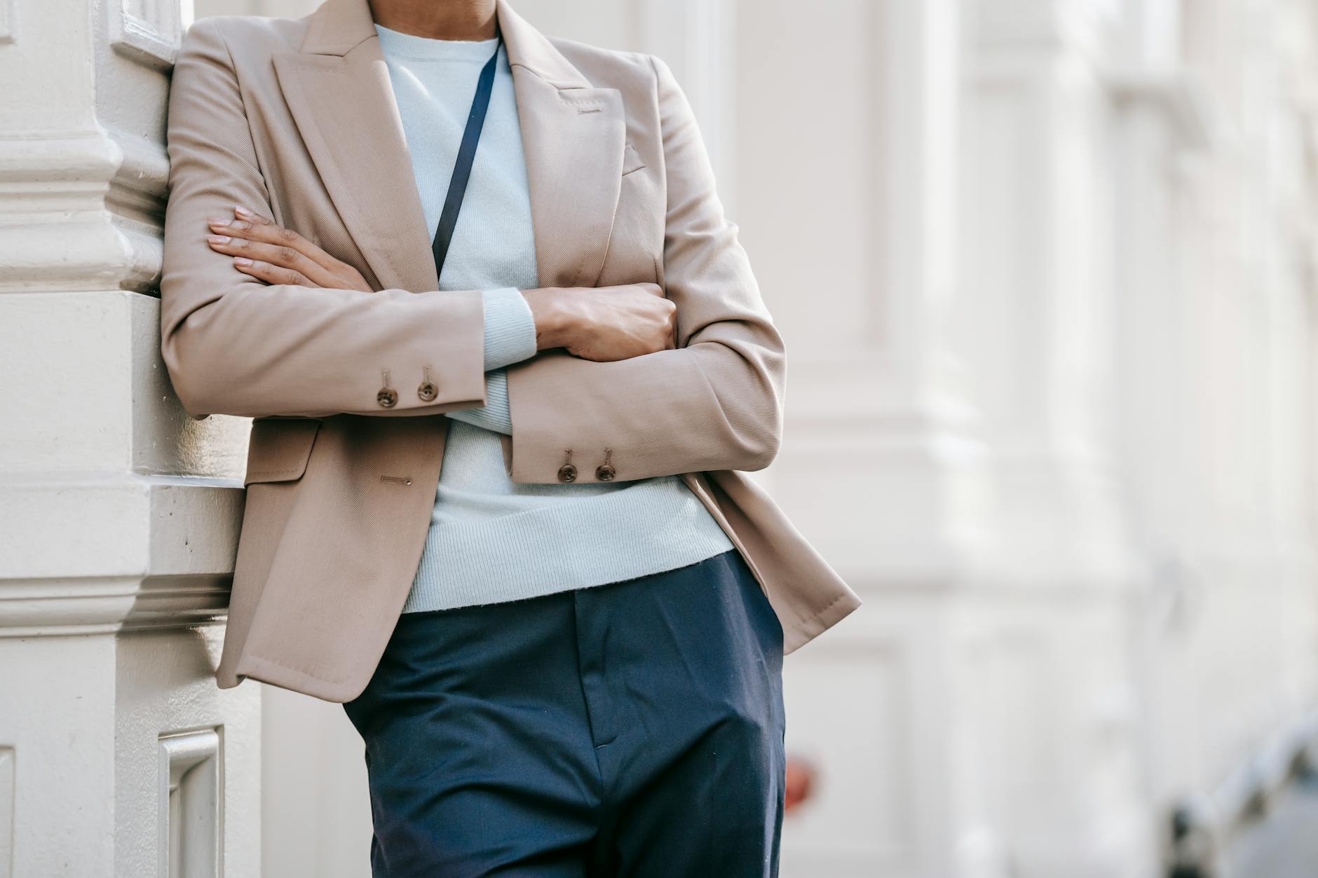 A structured navy blazer with contrast piping worn in a professional office setting