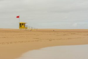 Lifeguard Tower Colour Palettes Are Drifting Into Resort Tailoring Brightly colored lifeguard tower on a sunny beach in bold orange and white