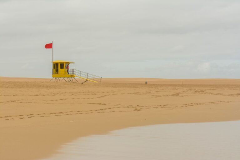 Lifeguard Tower Colour Palettes Are Drifting Into Resort Tailoring Brightly colored lifeguard tower on a sunny beach in bold orange and white
