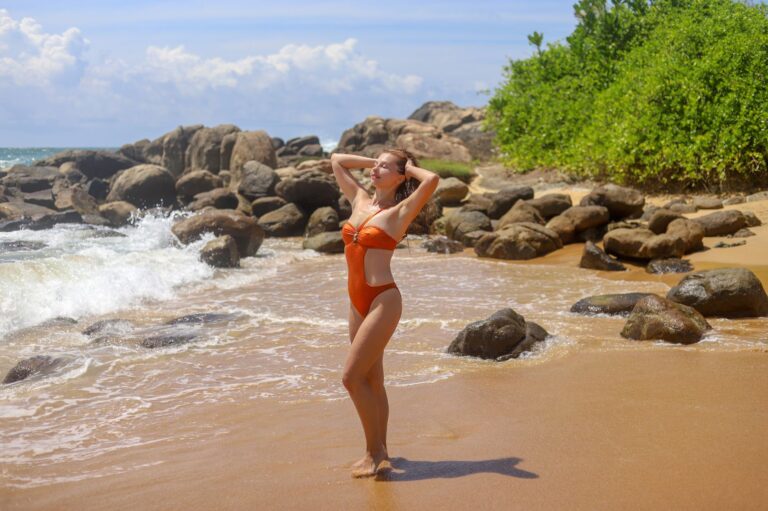 Woman wearing a long-sleeved rash vest style cover-up at the beach