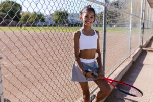 A person wearing a pleated athletic skort outdoors in casual streetwear styling