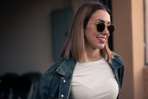 Person wearing oversized tortoiseshell sunglasses on a city street