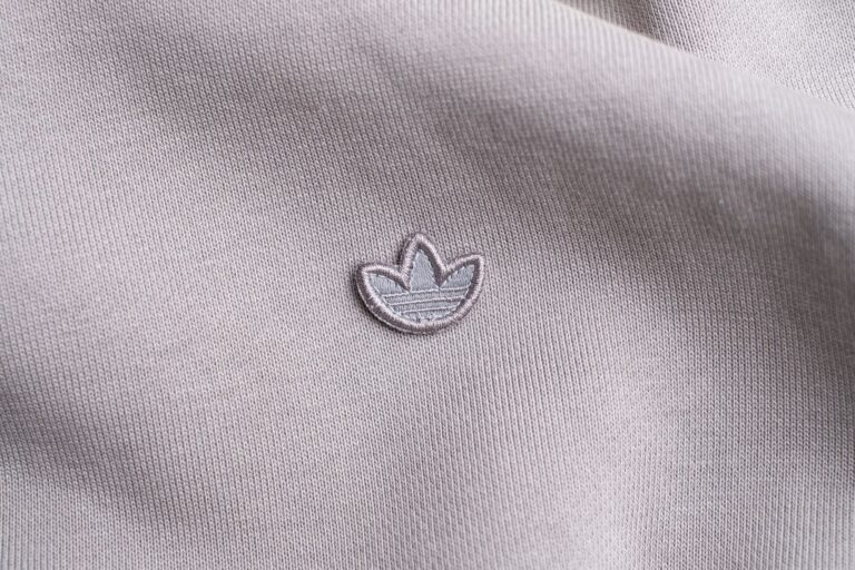 A colorblocked fleece pullover in classic collegiate colors laid flat on a neutral surface