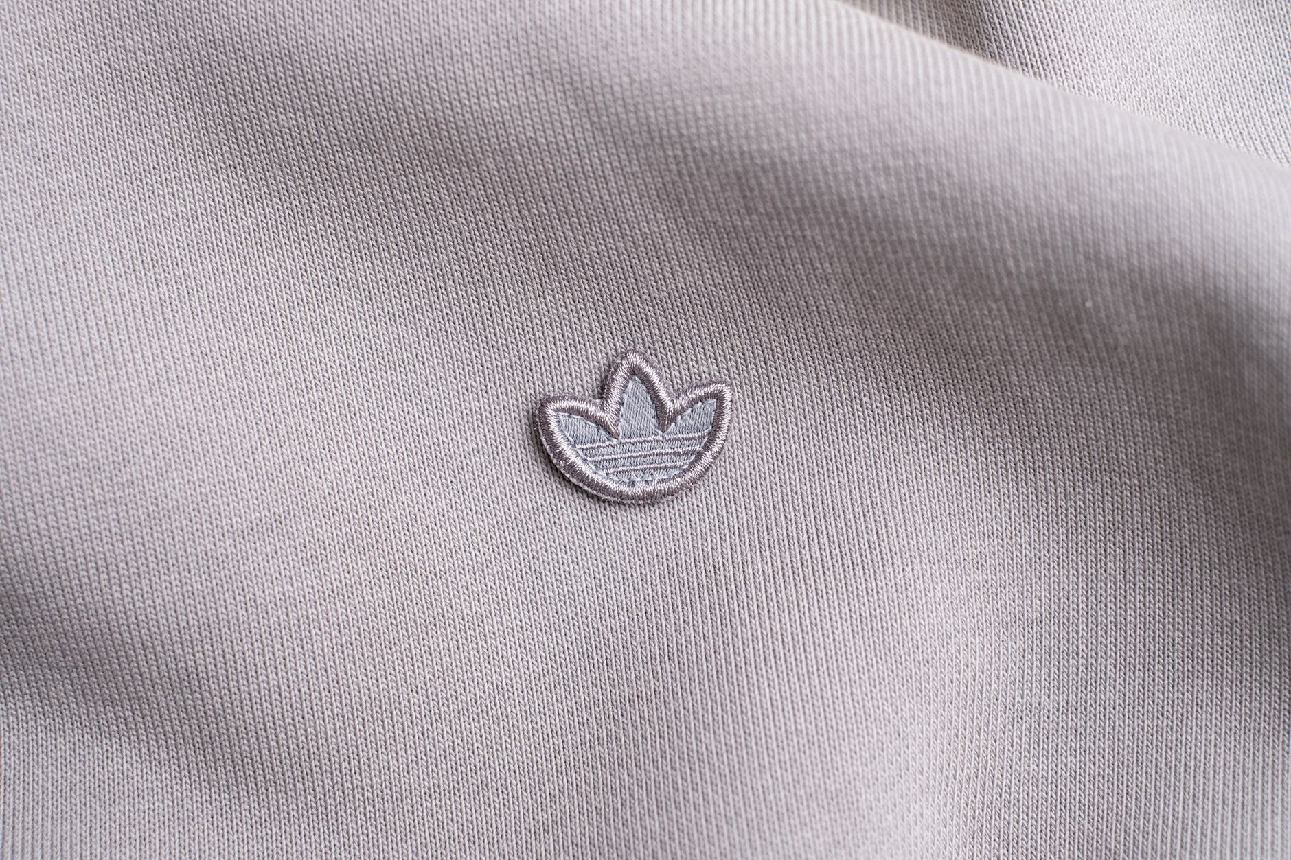 A colorblocked fleece pullover in classic collegiate colors laid flat on a neutral surface