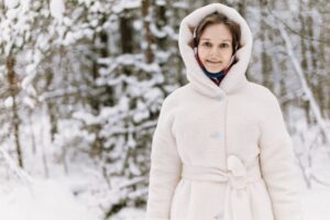 Polo Umpire Coats Are Drifting Into Oversized Outerwear Dressing A long double-breasted white coat with wide lapels and a boxy silhouette, referencing polo umpire outerwear styling
