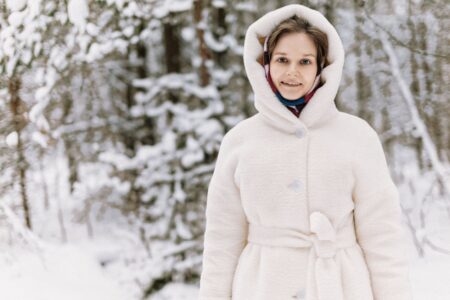 A long double-breasted white coat with wide lapels and a boxy silhouette, referencing polo umpire outerwear styling
