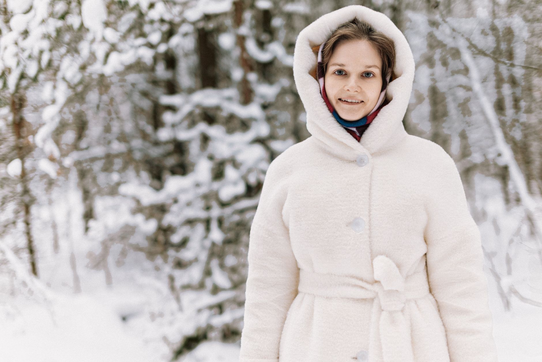 A long double-breasted white coat with wide lapels and a boxy silhouette, referencing polo umpire outerwear styling