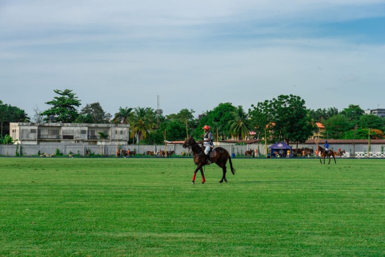 Polo Cross-Country Colours Are Galloping Into Knitwear Palettes Polo players on horseback in bright team colours during a cross-country match
