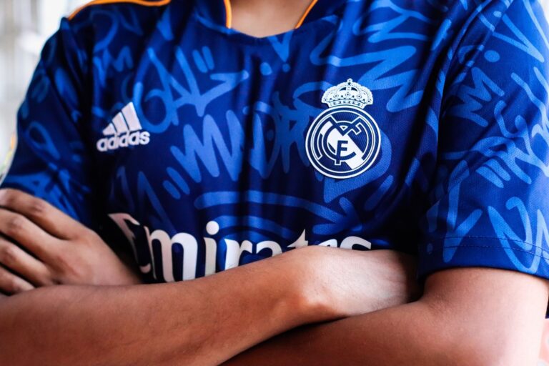 Close-up of a brightly colored sports jersey with bold graphic crest detail