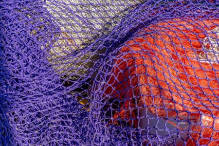 Close-up of athletic mesh fabric texture showing open-weave construction