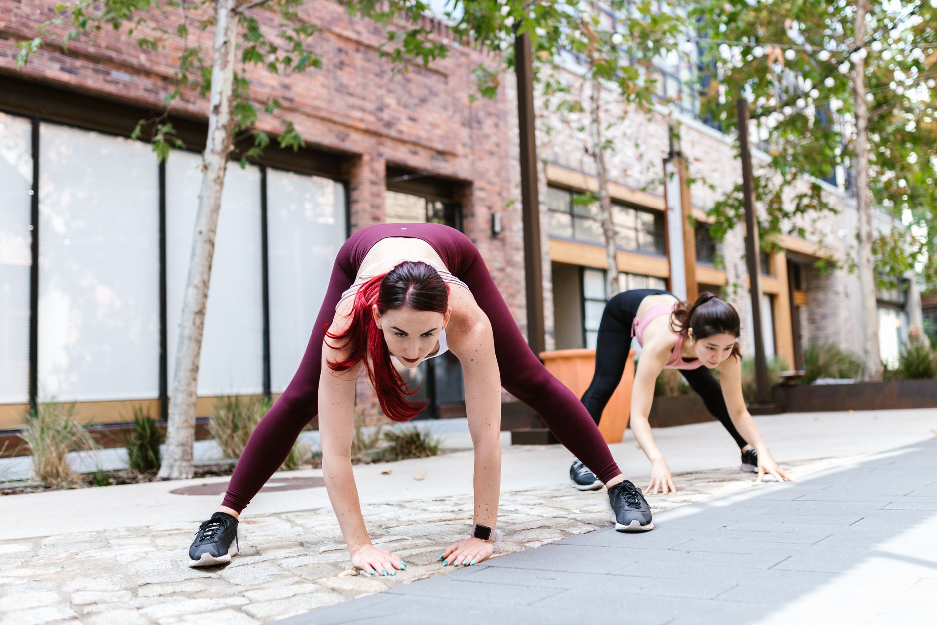 Women in athleisure outfits walking on a city street combining sportswear and casual pieces