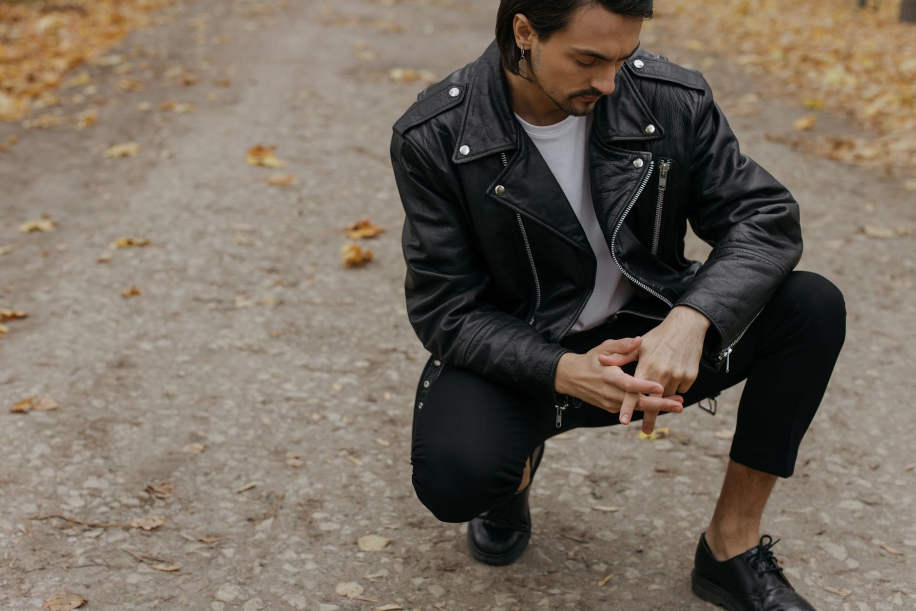 Layered streetwear outfit combining athletic and tailored garments