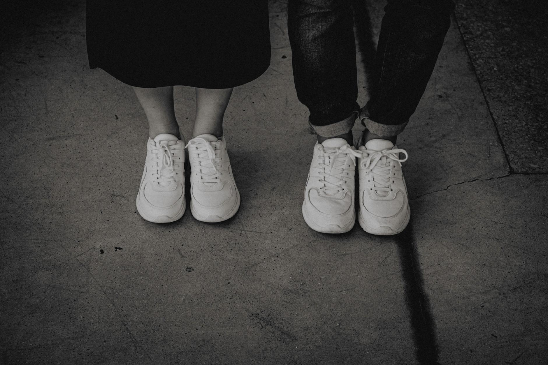 Close-up of flat-soled minimalist sneakers worn on a city street