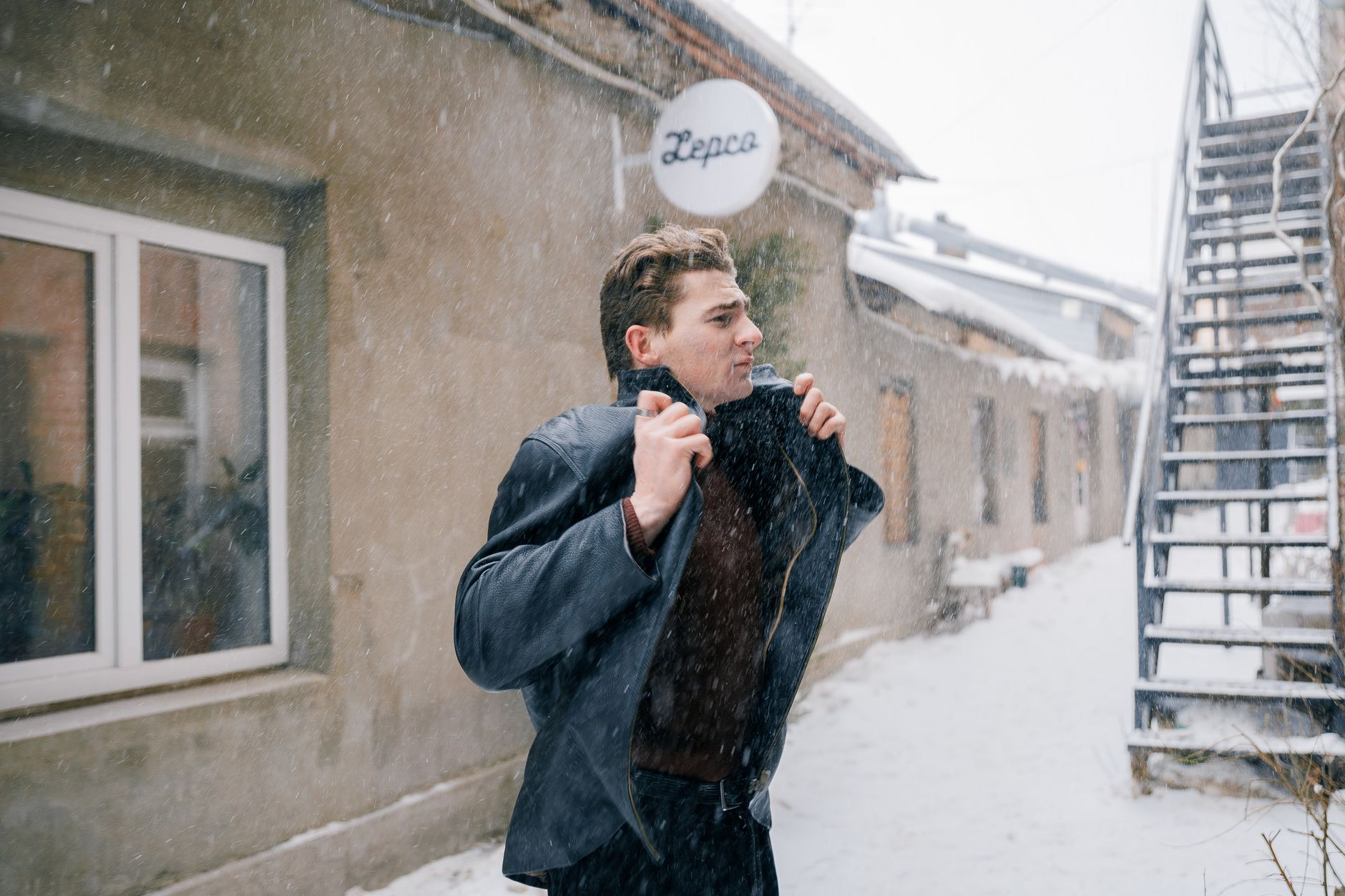 A model wearing oversized utilitarian outerwear on a city street