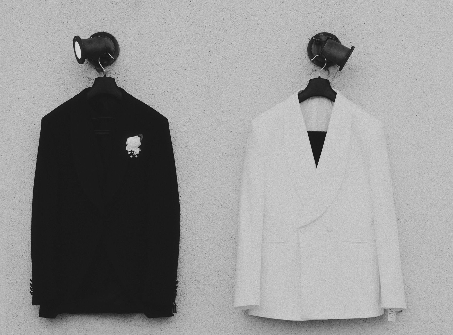 Person in a fitted blazer with structured neckwear, minimal and formal styling