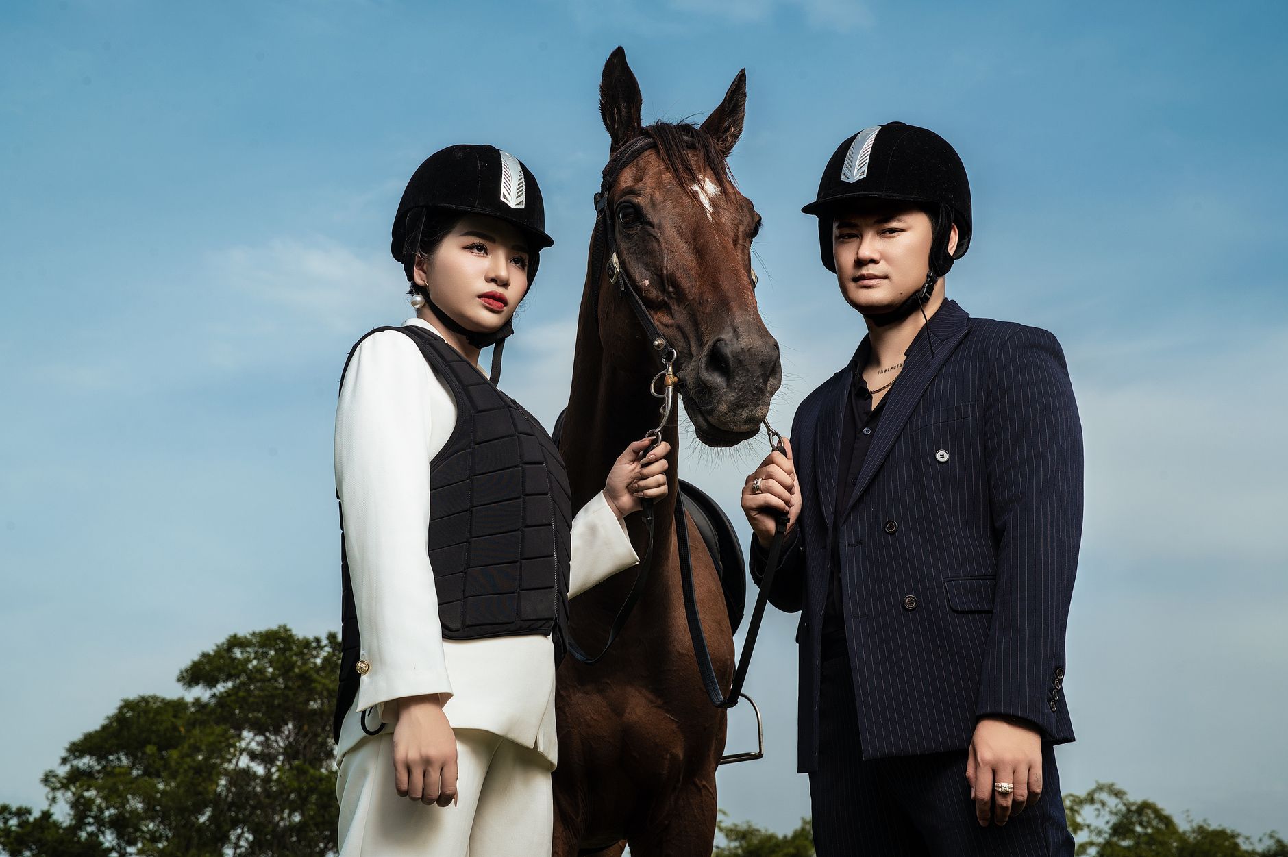 Model styled in equestrian-inspired layered knitwear with tailored trousers and leather boots