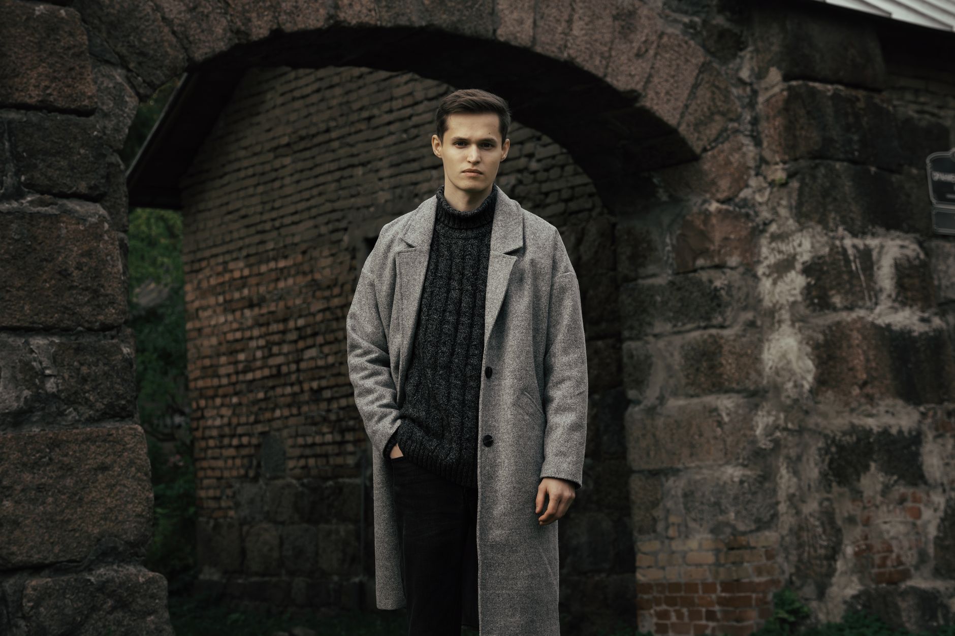 Editorial fashion shot featuring structured tapered trousers styled with a long blazer