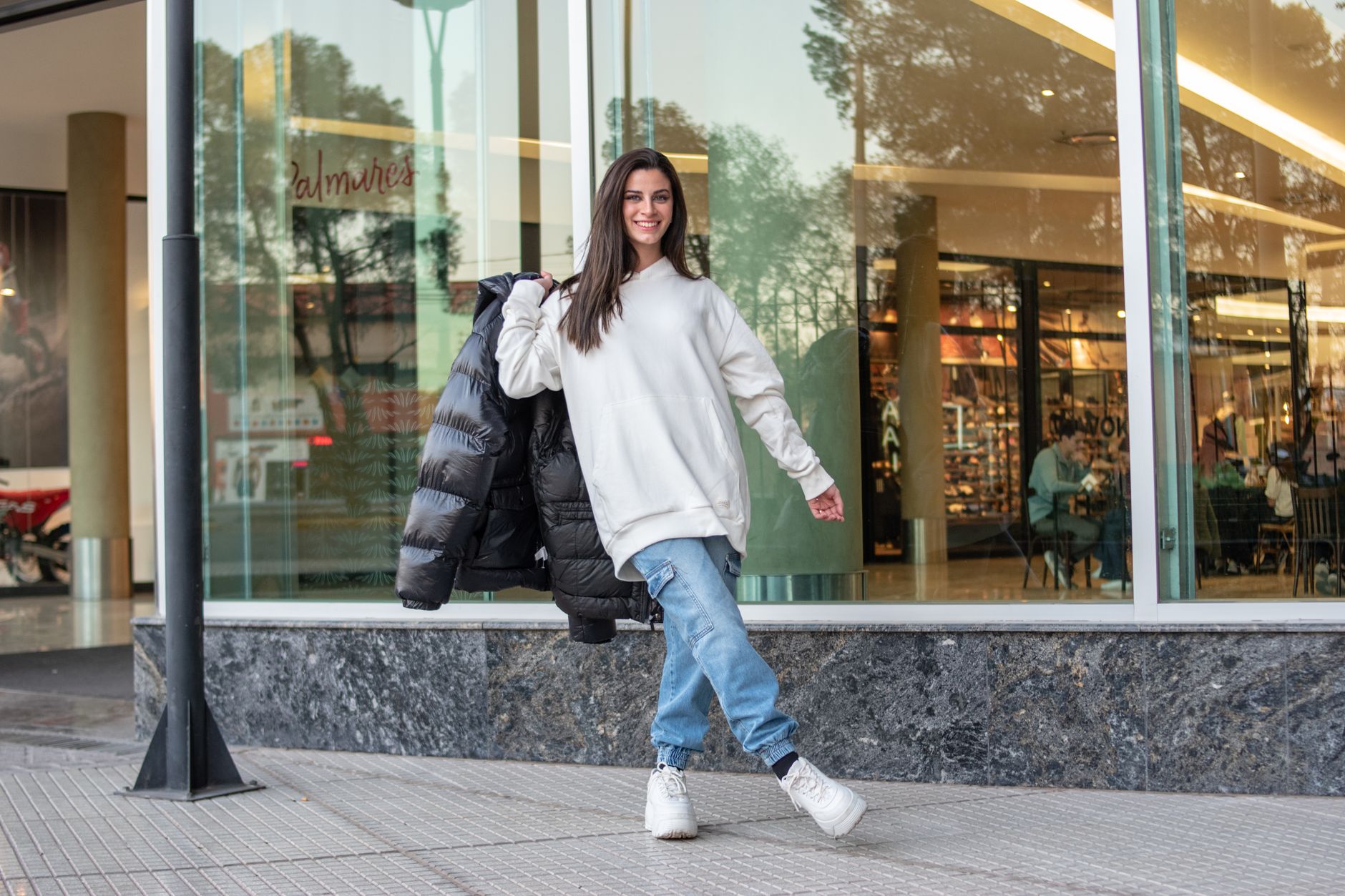 Street style outfit featuring bold athletic top styled with tailored trousers