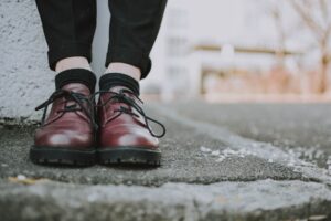 Close-up of structured ankle paddock boots worn on a city sidewalk