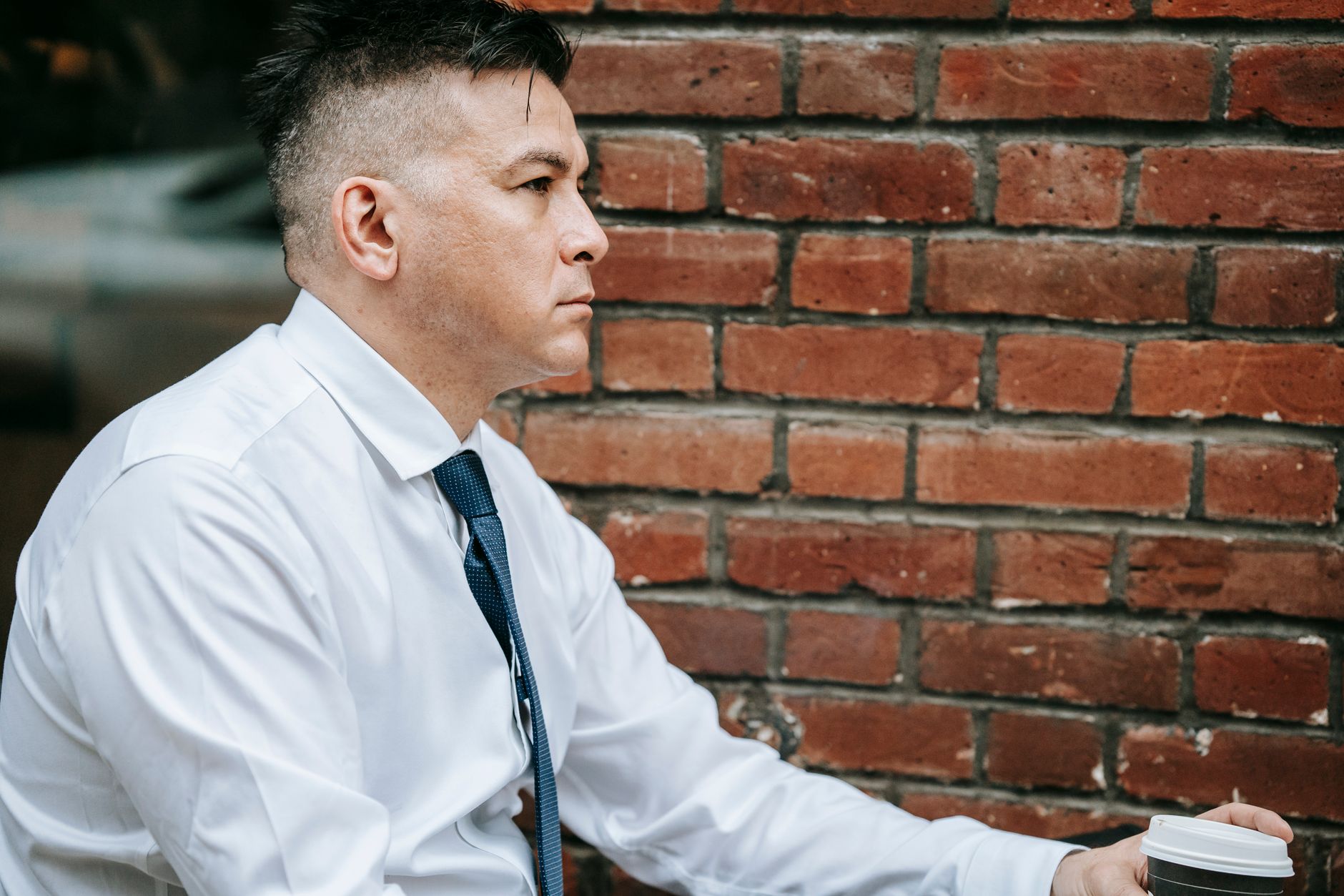 Close-up of a crisp white button-down shirt with a structured collar, styled minimally