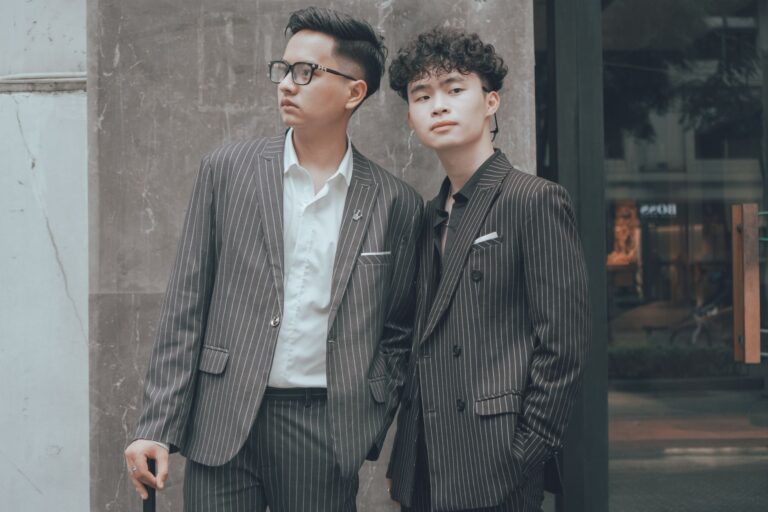 Rowing Club Striped Blazers Are Drifting Into Evening Dressing A bold striped blazer laid flat, showing wide navy and cream rowing club stripes