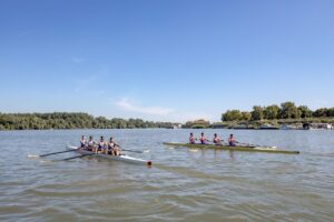 Rowing team on a river in fitted athletic leggings during training