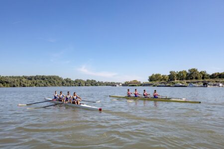 Eton College Rowing Leggings Are Quietly Sculpting Luxury Activewear Rowing team on a river in fitted athletic leggings during training