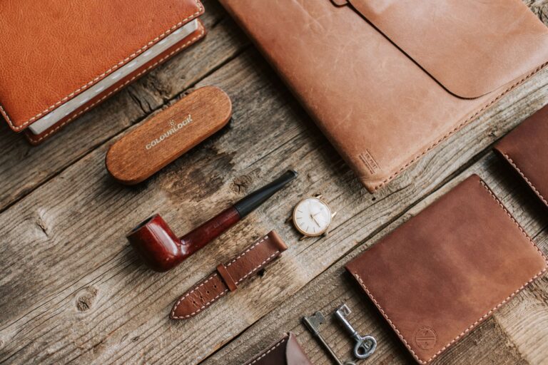 Close-up of hand-stitched leather wallet showing saddle stitch detail along the border