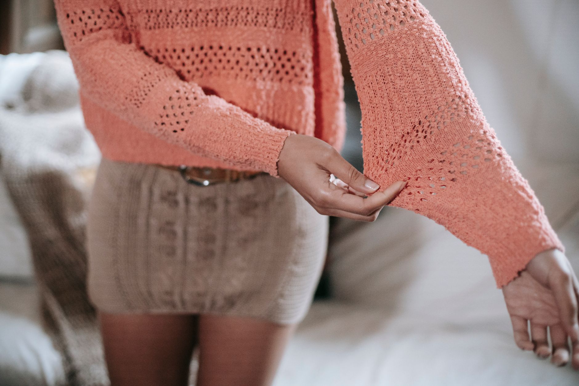 Close-up detail of a graphic knit sweater showing contrast panel and number motif